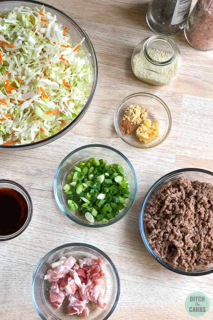 All the ingredients needed to make keto crack slaw in clear glass bowls.
