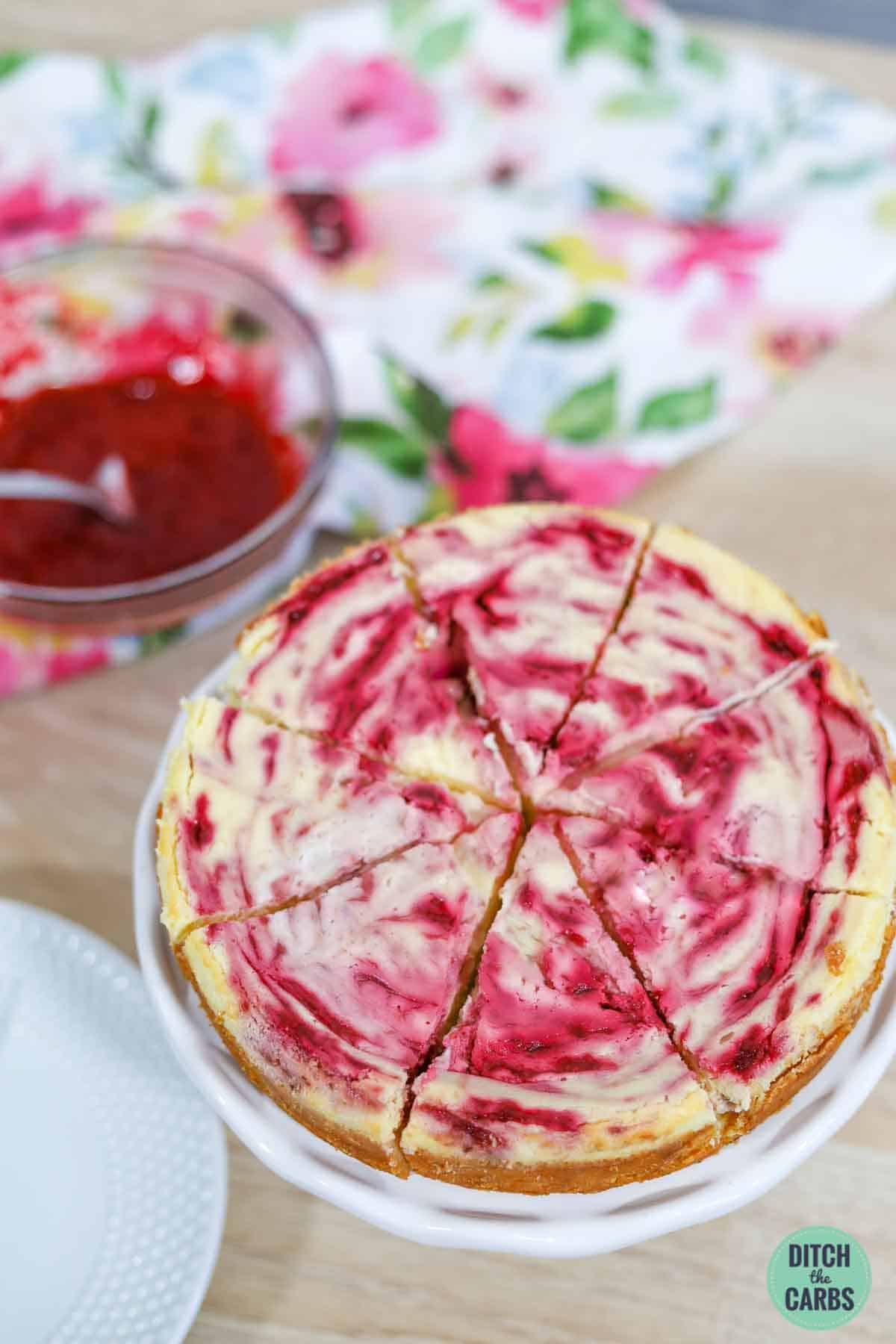 keto raspberry cheesecake baked and sliced into 8 pieces