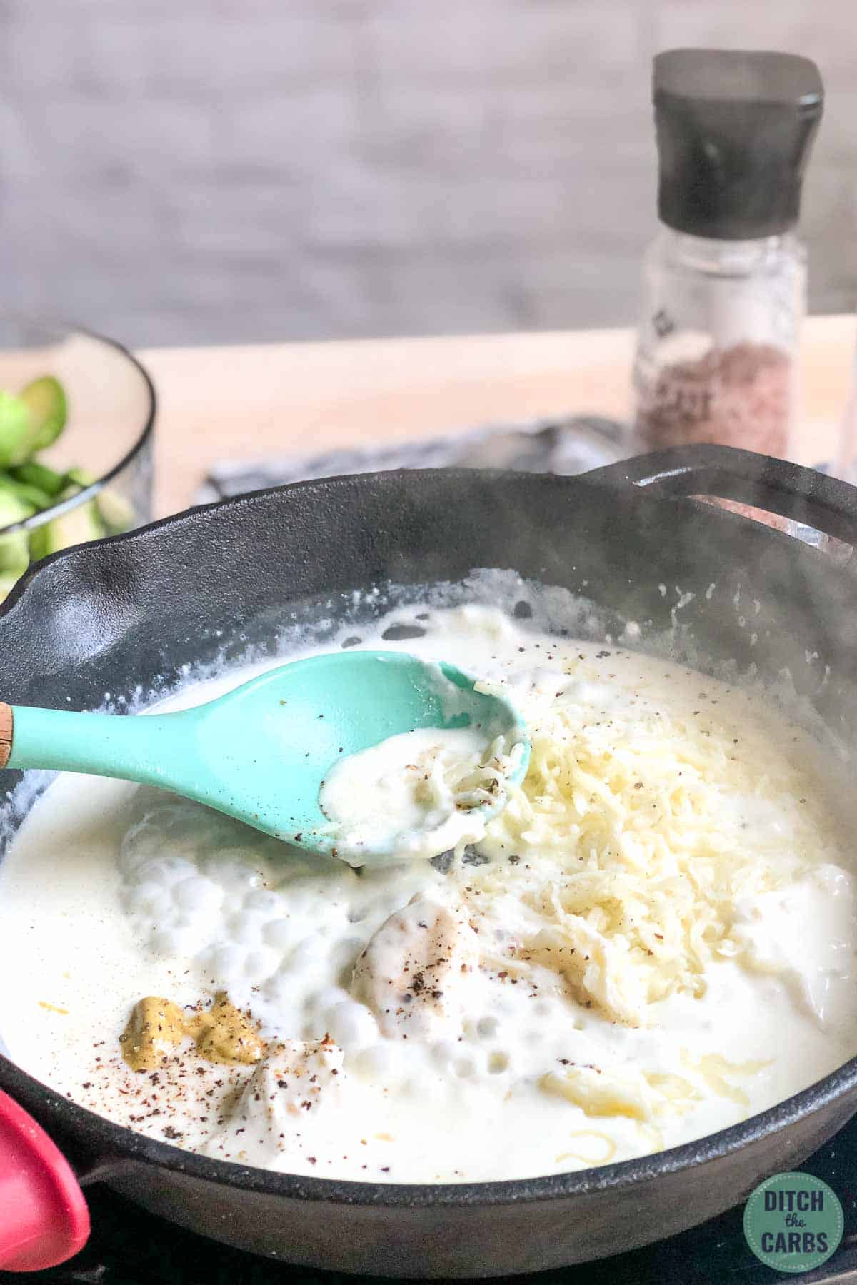 Meting cheese into a heavy cream sauce for creamy brussels