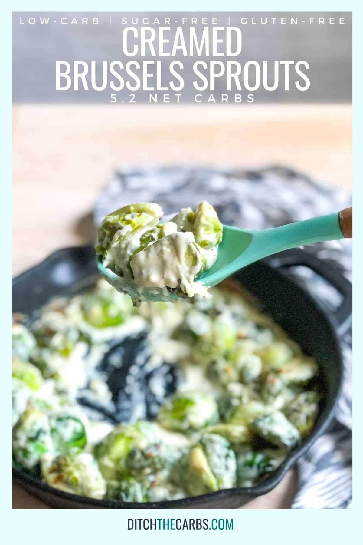 A light green spoon is lifting a spoonful of creamed brussels sprouts out of a cast-iron skillet.