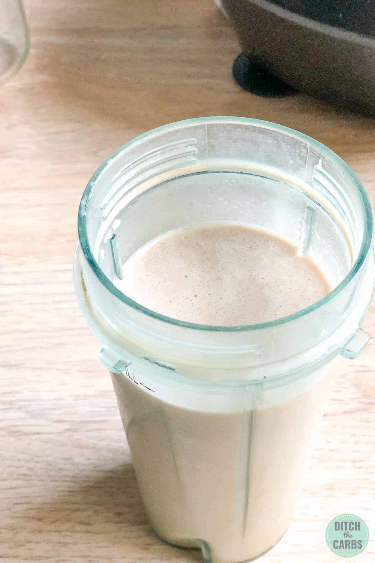 The chocolate peanut butter smoothie has been blended. The lid to the blender has been removed to show the finished smoothie.
