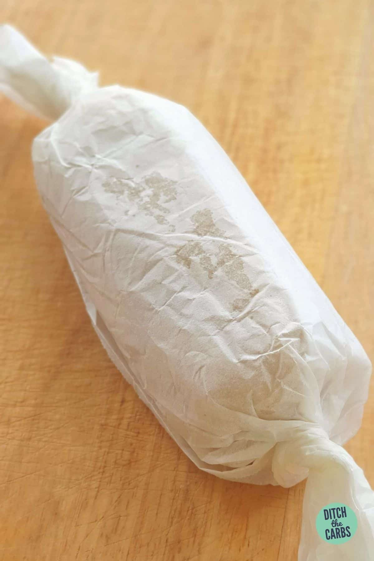 keto sugar-free marzipan rolled into a log then wrapped in baking parchment