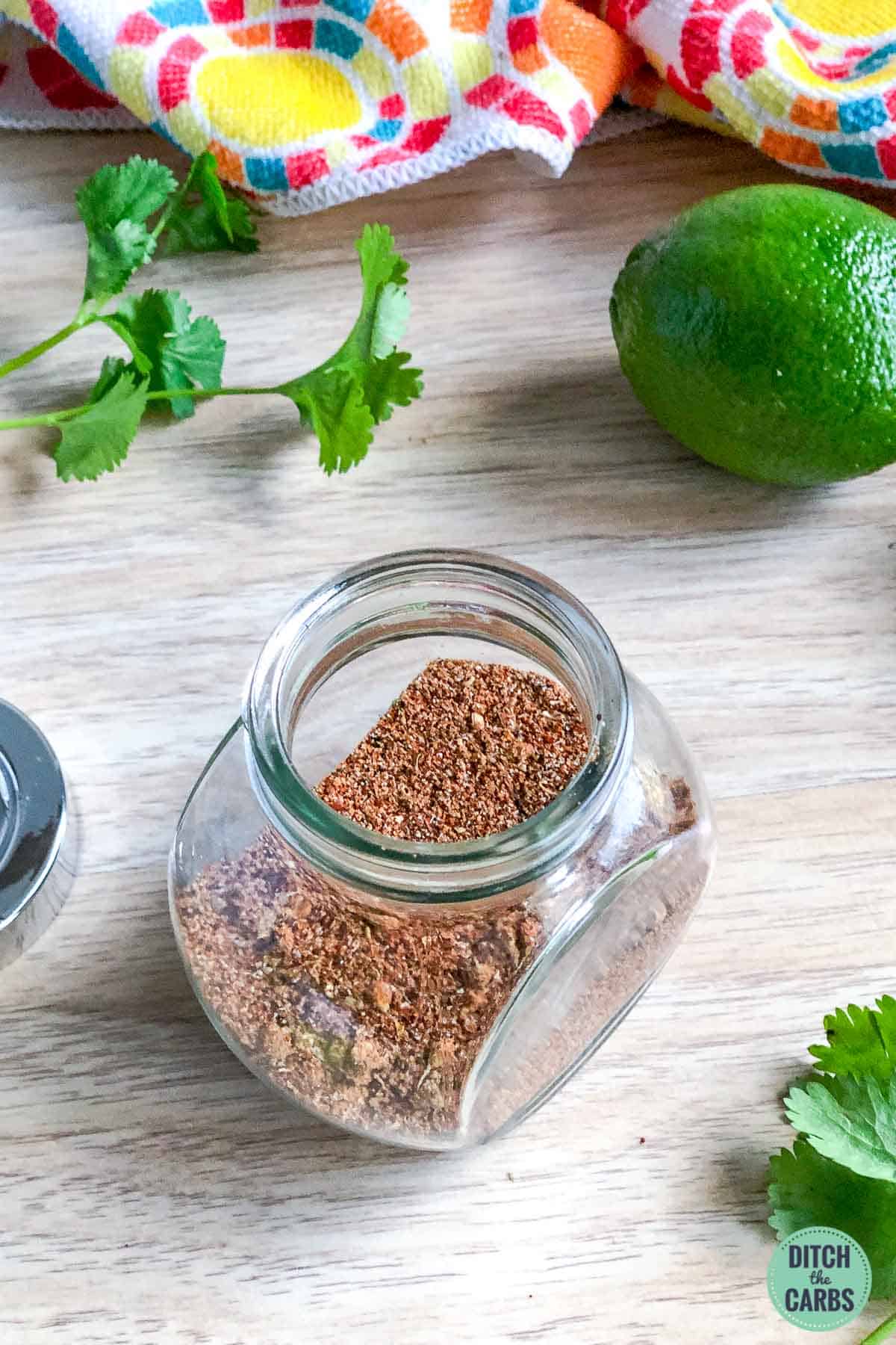 Glass jar filled with a homemade taco seasoning blend