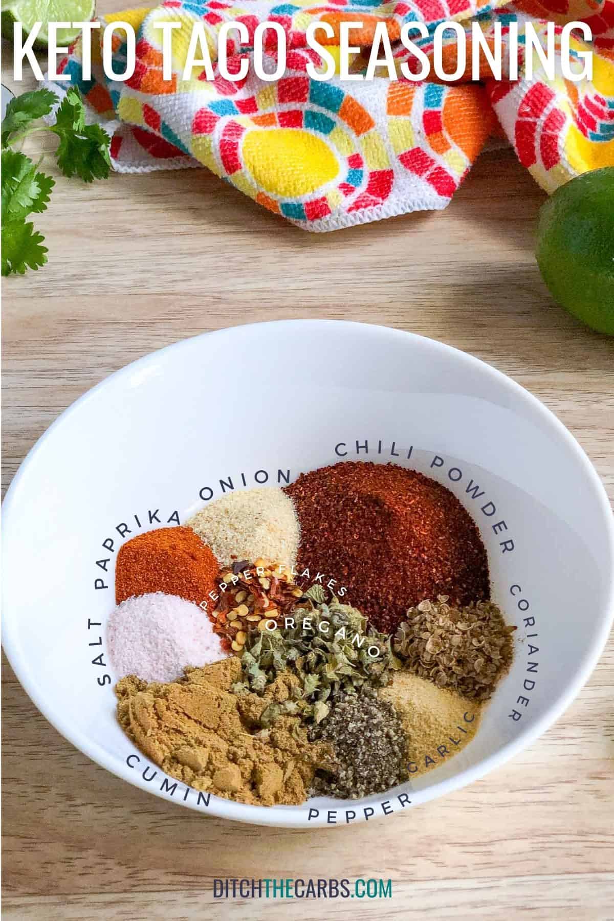 Different spices that make up taco seasoning - salt, paprika, onion, chili powder, coriander, oregano, pepper flakes, cumin, garlic, and pepper.