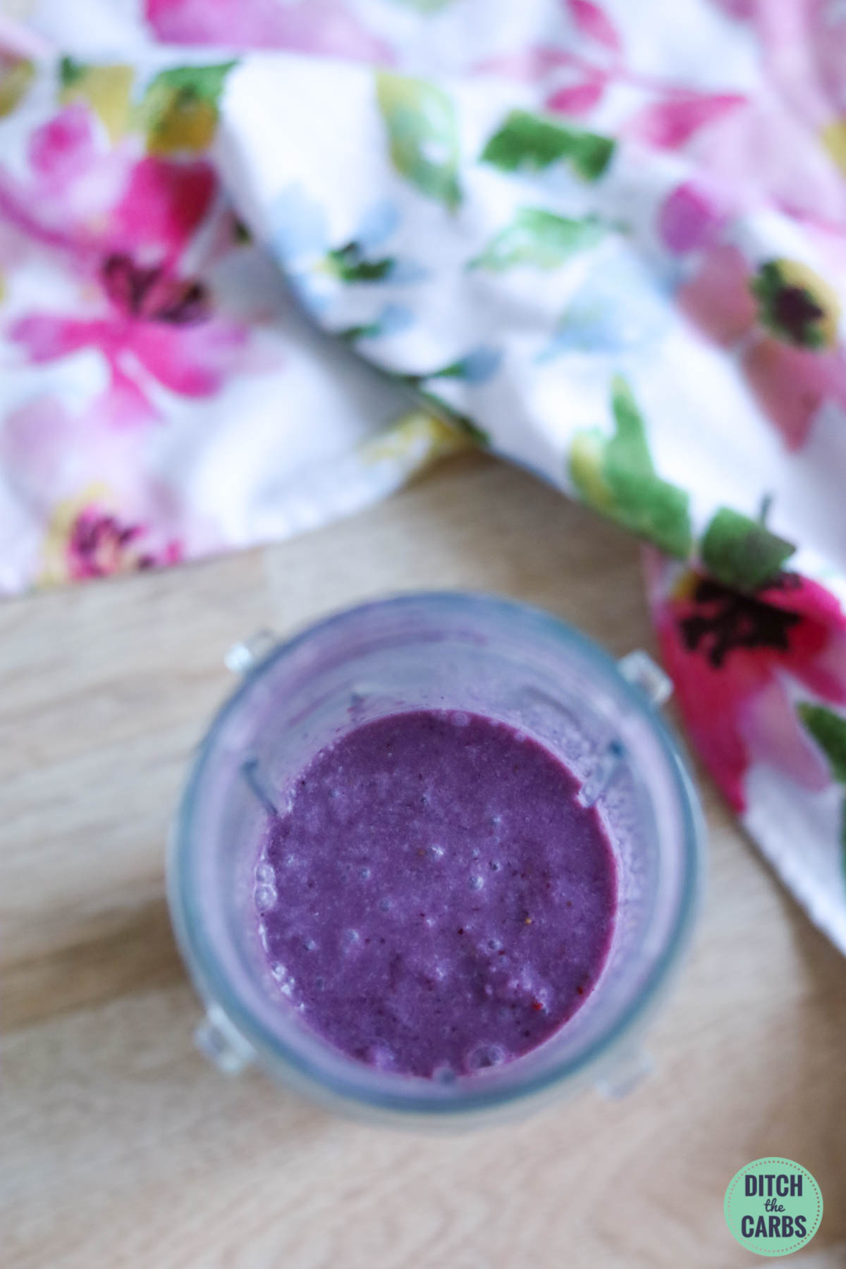 Aerial view of a purple keto berry smoothie in a blender