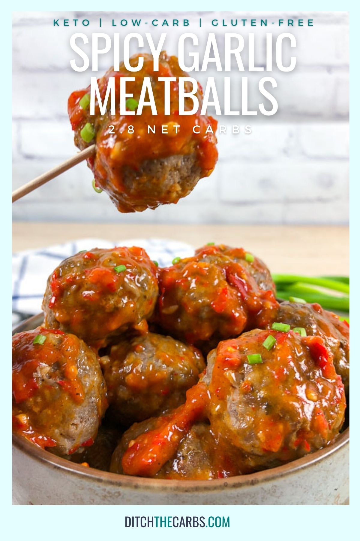 A toothpick is lifting a keto spicy garlic meatballs our of bowl filled with meatballs.