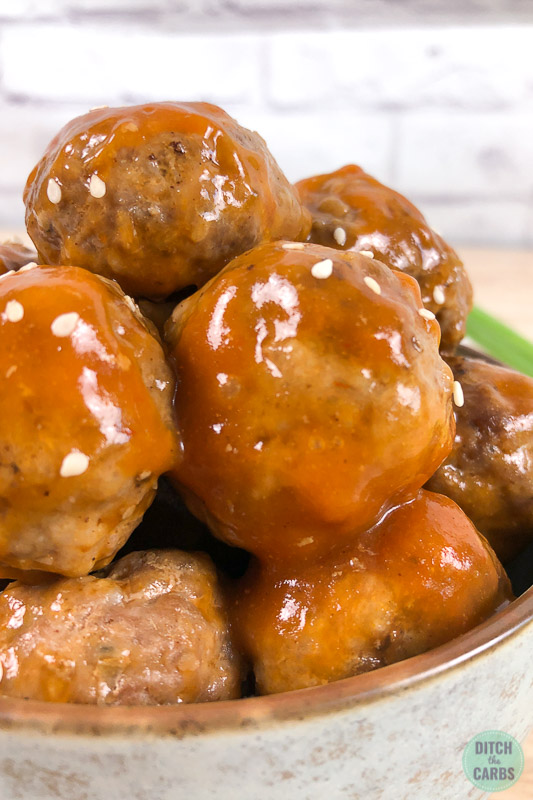 Close up of sweet and sour sauce coating meatballs