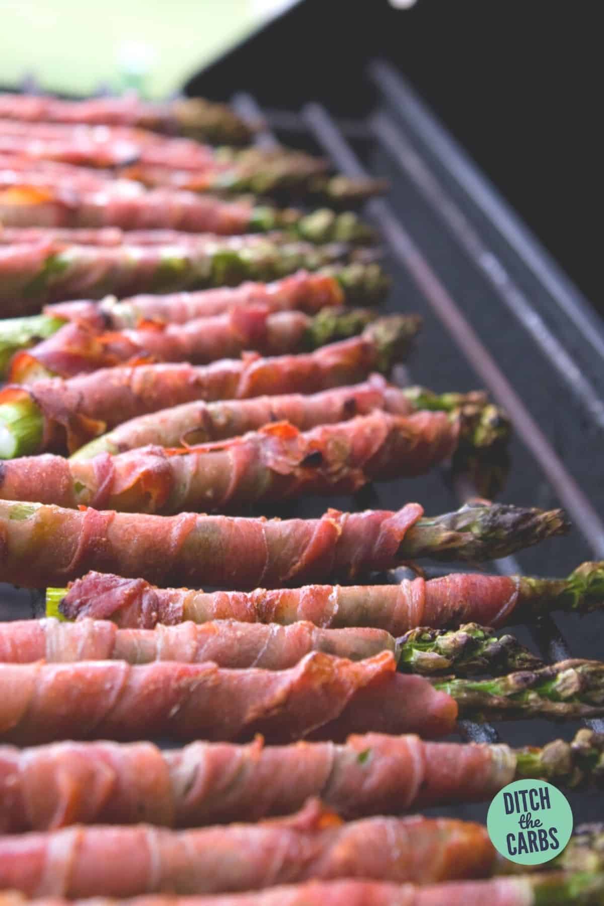bacon wrapped asparagus cooking on a BBQ