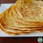 keto crepes piles on a white square plate