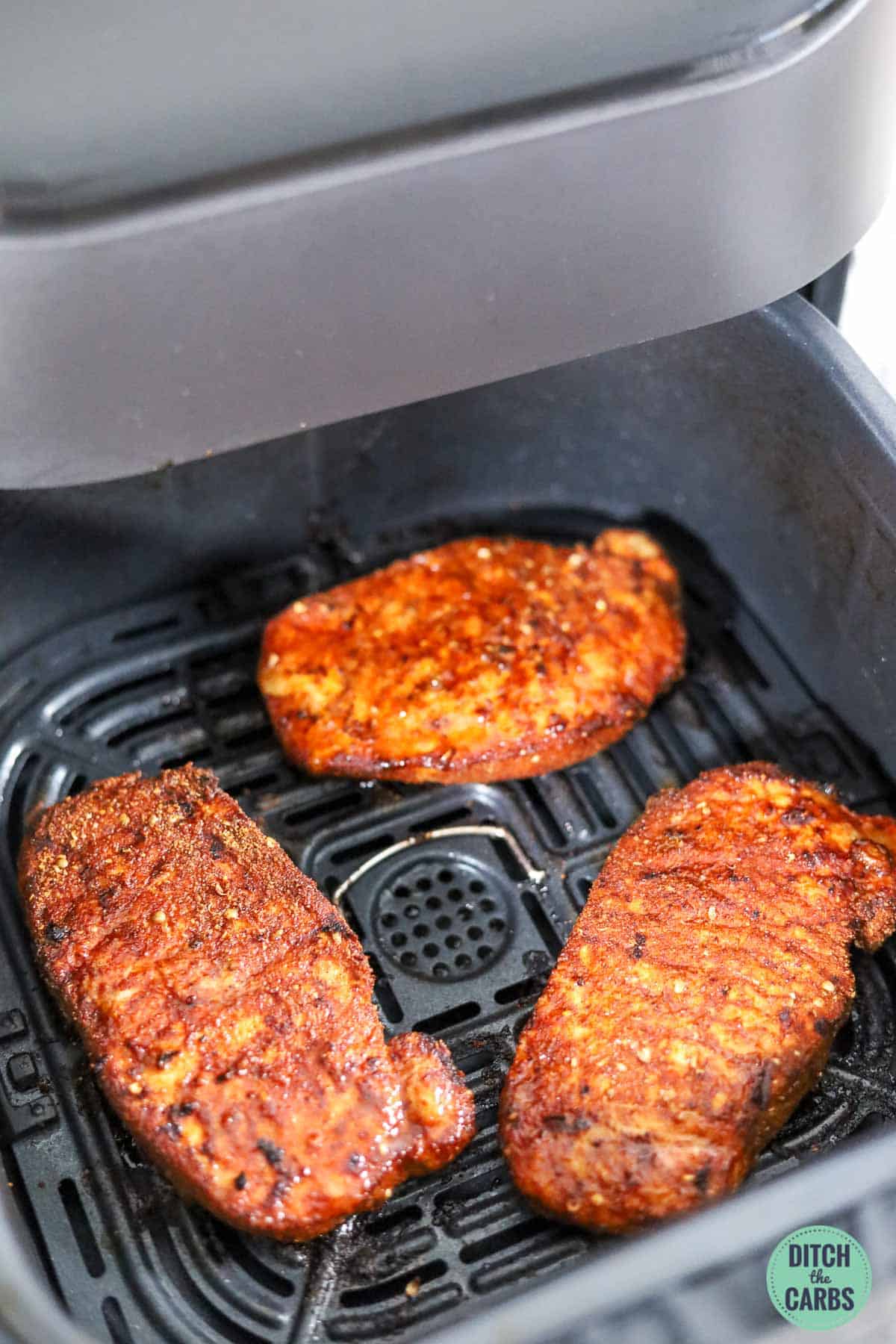 The only guide you'll ever need to learn how to cook any pork chop in an air fryer! #ketoporkchops #airfryer #ditchthecarbs