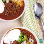 A plate of Instant Pot chili covered with shredded cheese