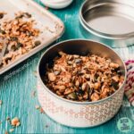 Homemade grain-free granola ingredients in a tinc