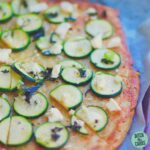 green vegetarian pizza served on baking paper