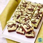 No Bake Chocolate Peppermint Cheesecake Squares served on a white dish with a green napkin