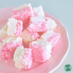 pink and white sugar-free coconut ice on a pink plate