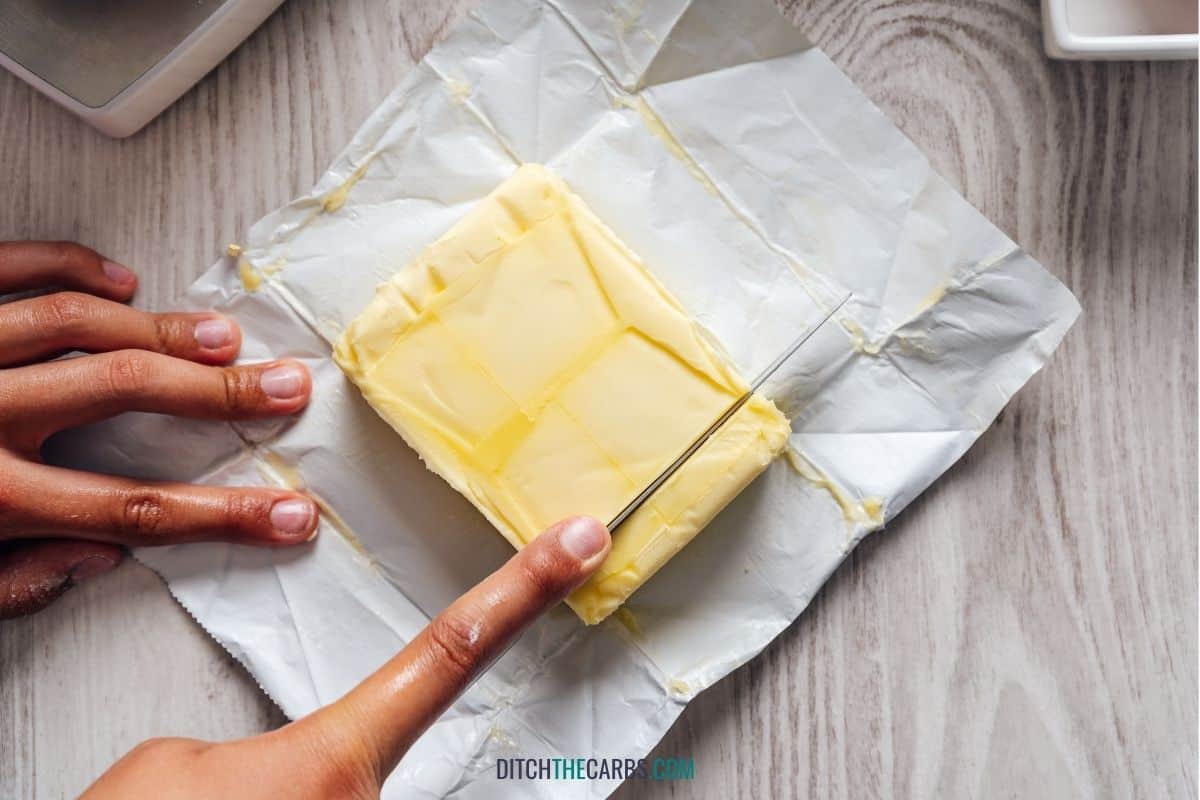 hands cutting butter