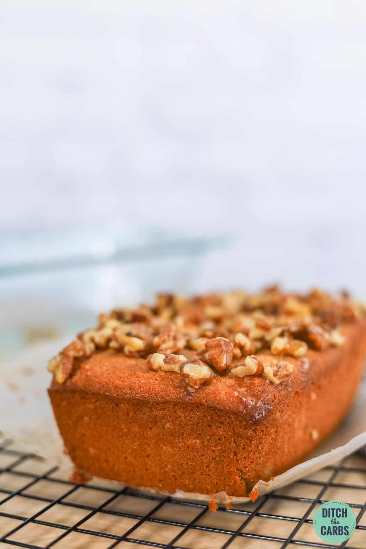 loaf of low carb banana bread topped with walnuts