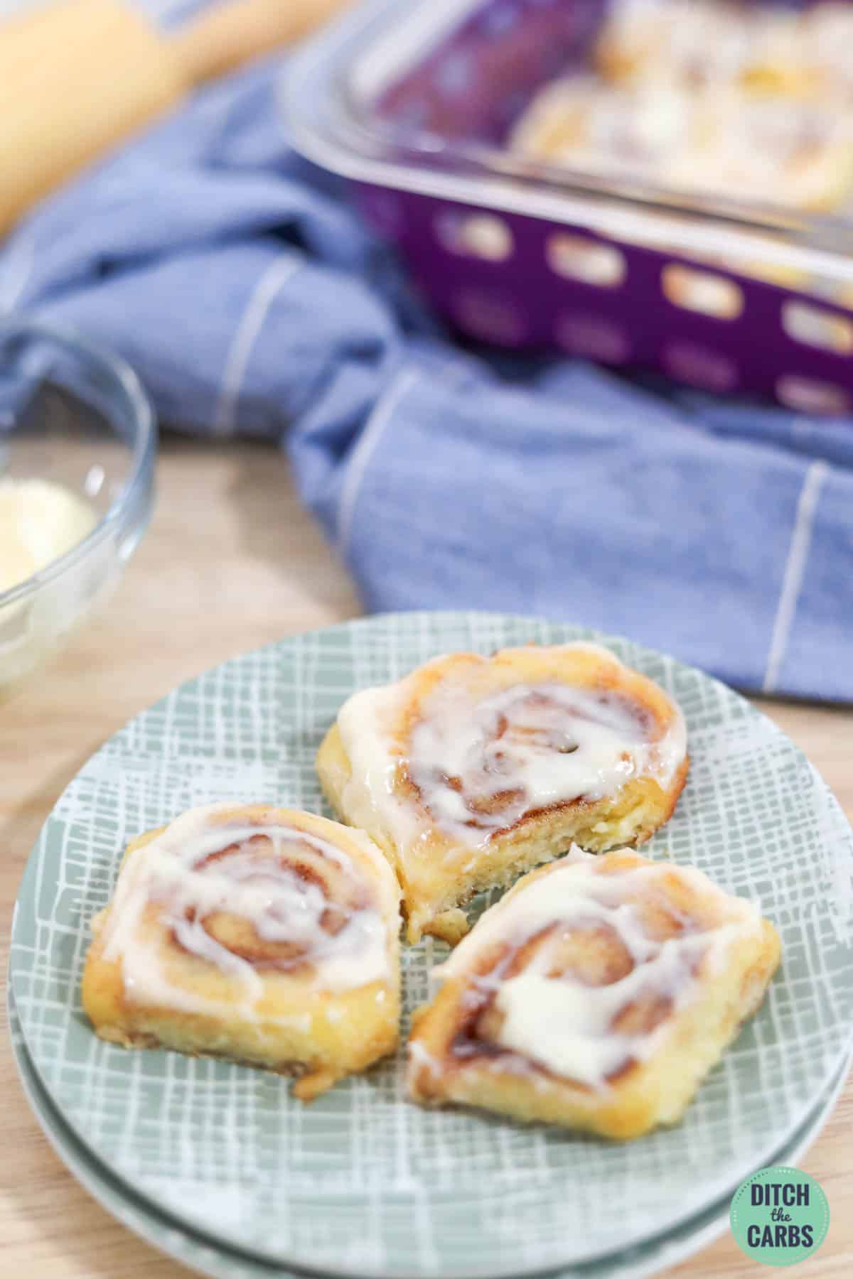 keto cinnamon rolls on a plate with frosting