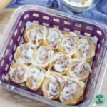 Keto cinnamon rolls with sugar-free cream cheese frosting still in the pan.