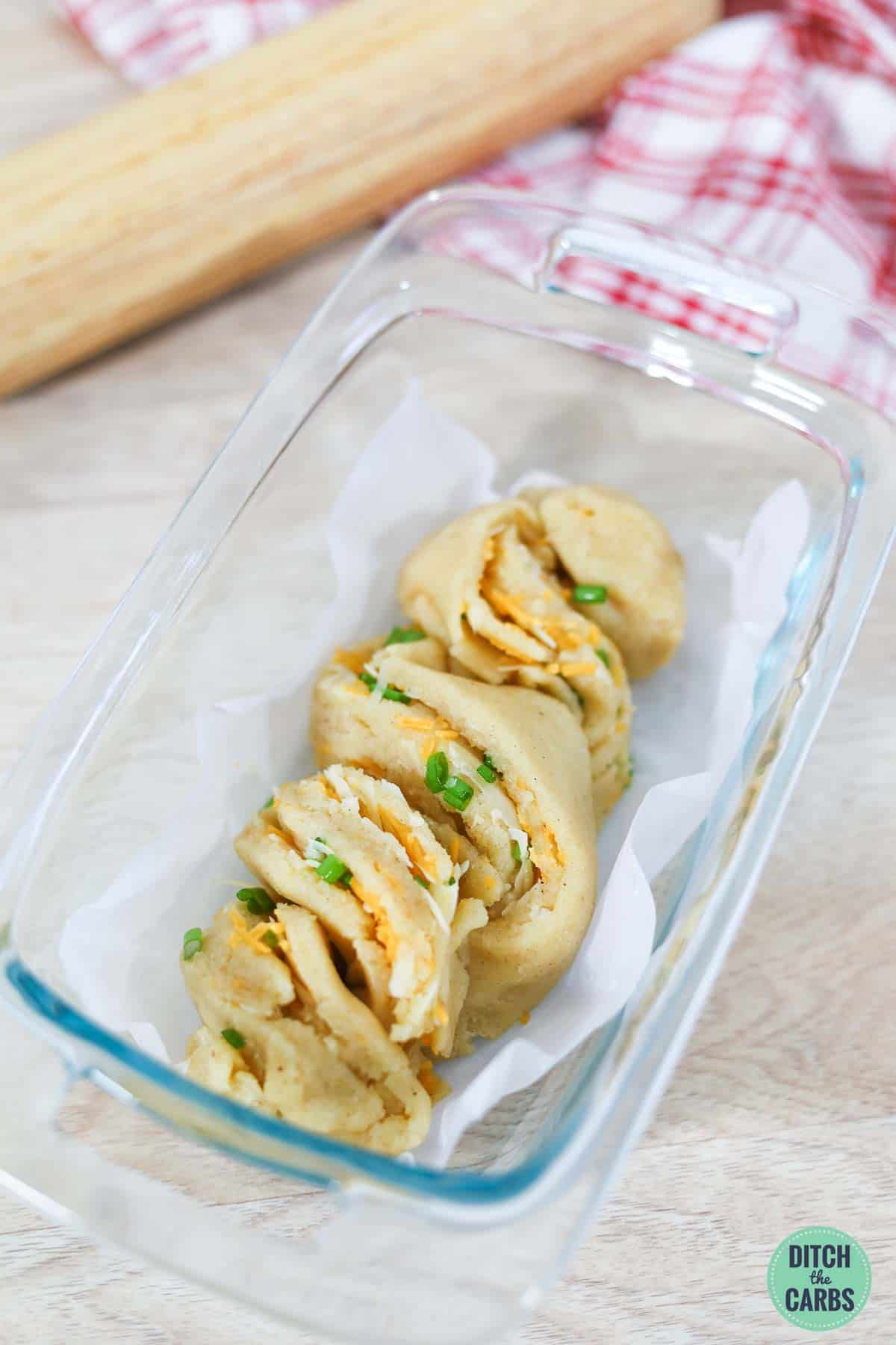 plaited keto cheese bread in a glass baking pan