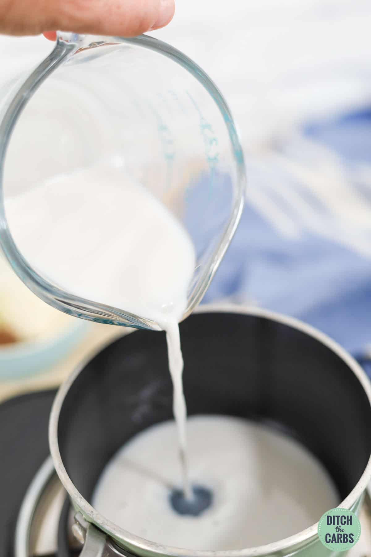 almond milk being poured into a saucepan