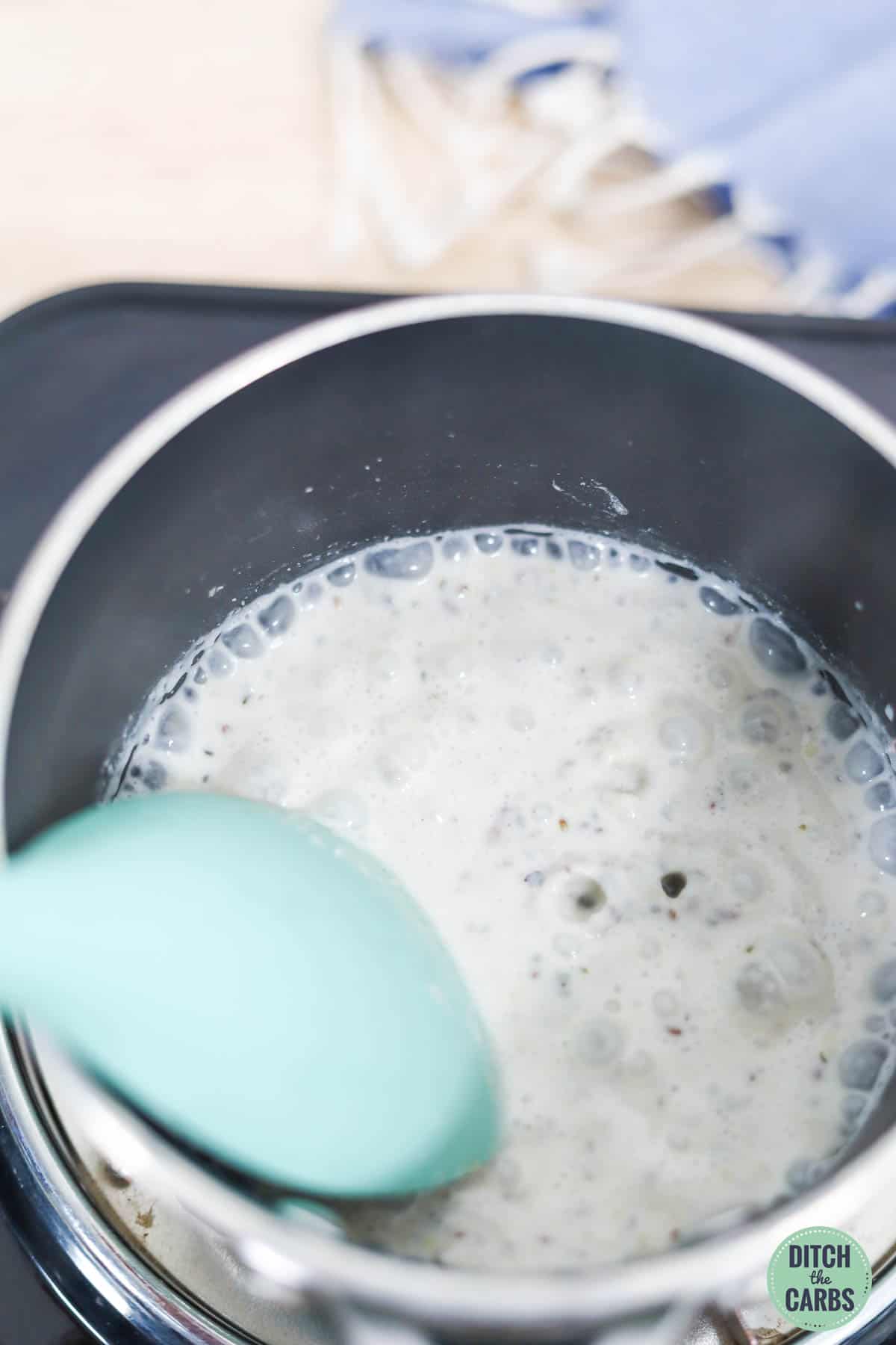 a small saucepan with bubbling milk