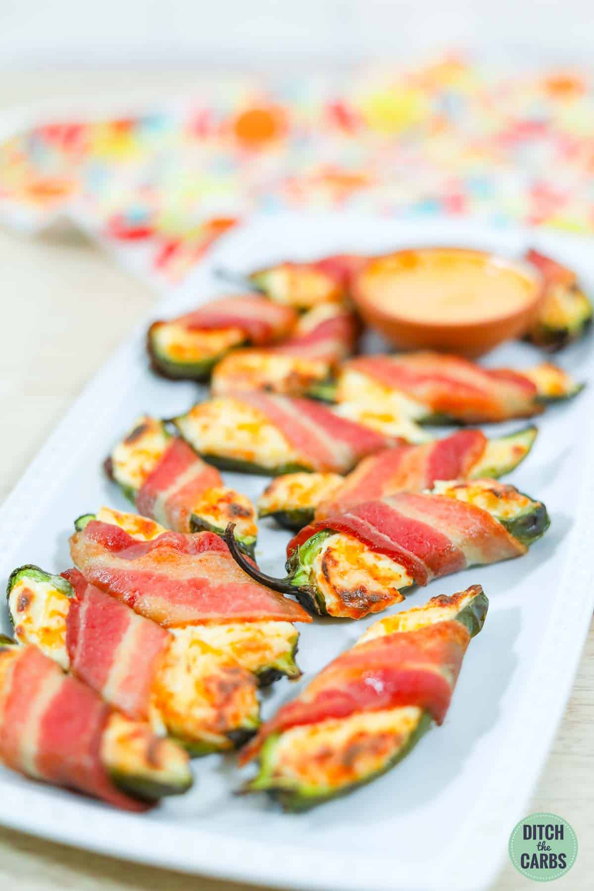 low carb baked jalapenos stuffed with cheese and wrapped in bacon