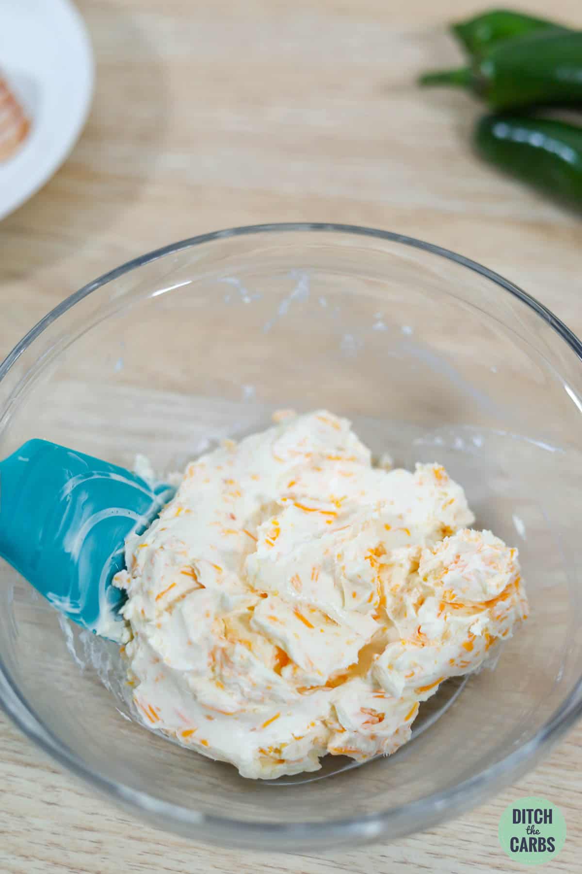 Mixing cream cheese with cheddar cheese