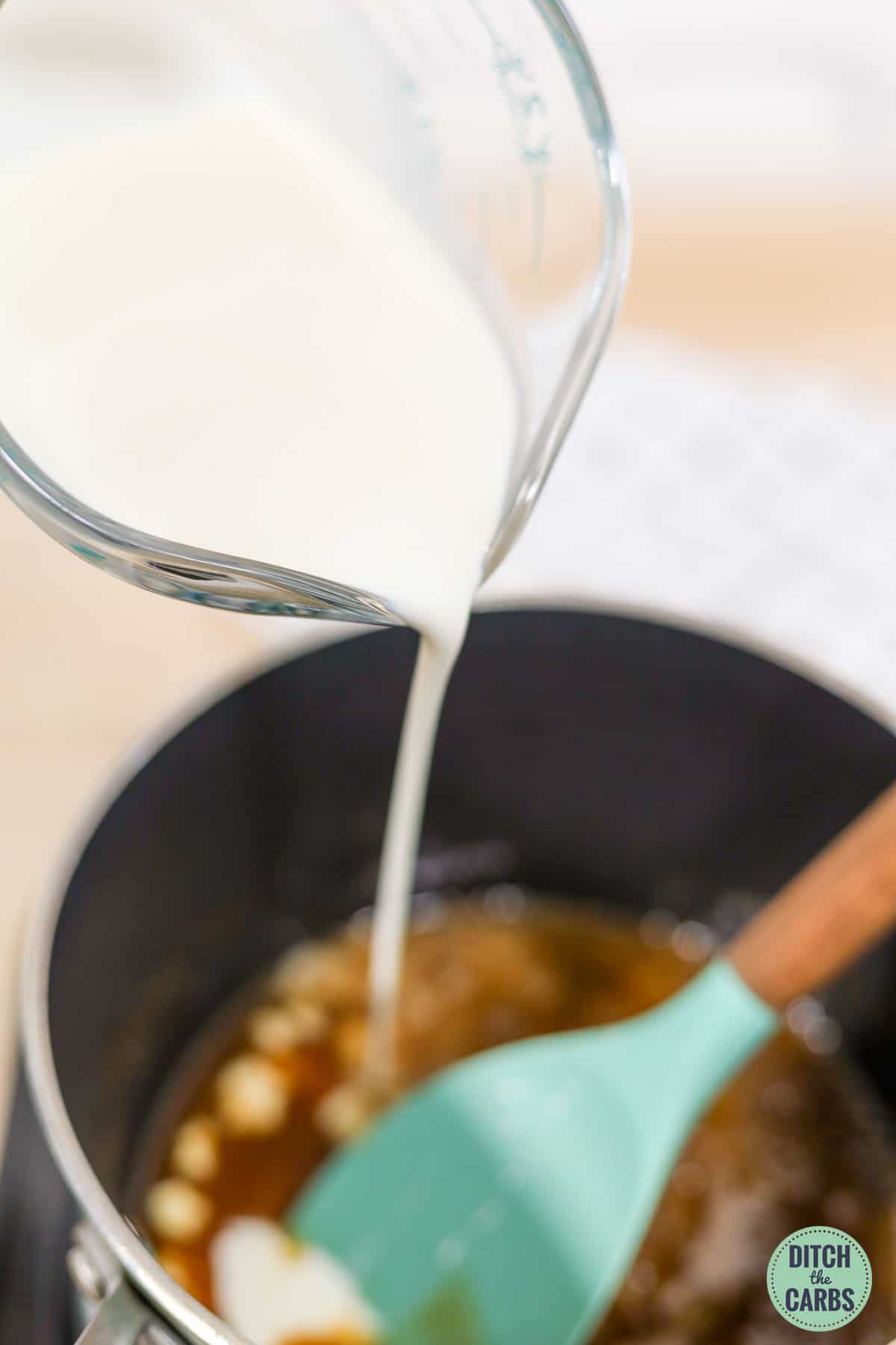 pouring heavy cream from a measuring glass