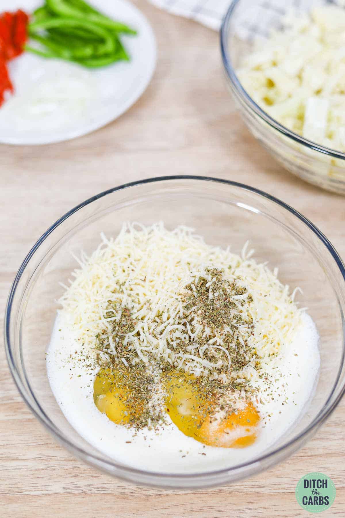 eggs, cheese, cream  and seasonings in a bowl