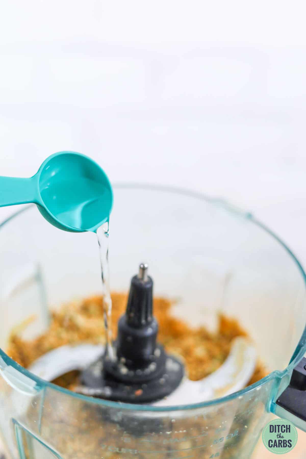 adding spoonful of water to recipe