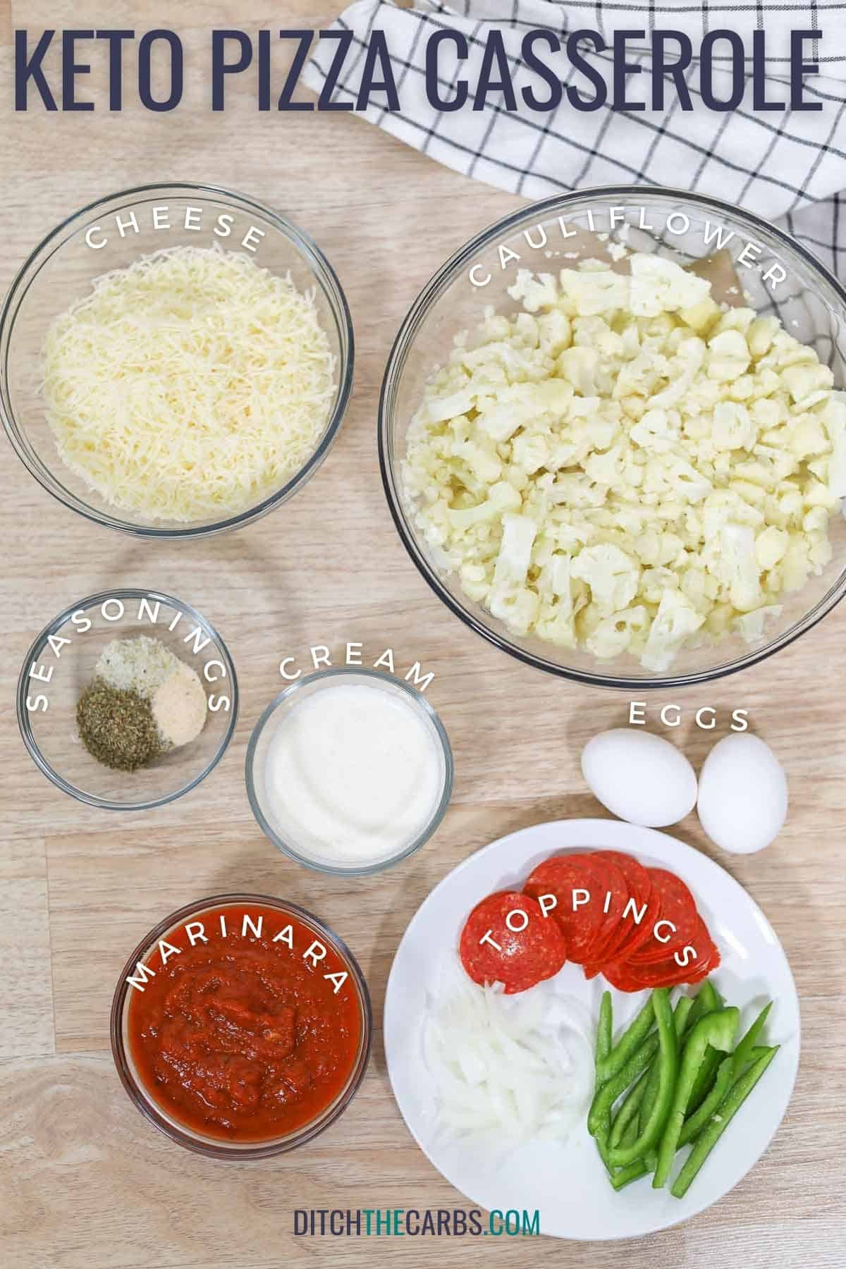 All the ingredients needed to make keto pizza casserole are measured and place in clear glass bowls on the counter.