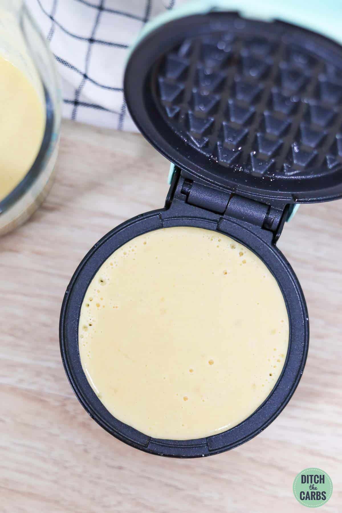 Almond flour waffles being made in a waffle iron