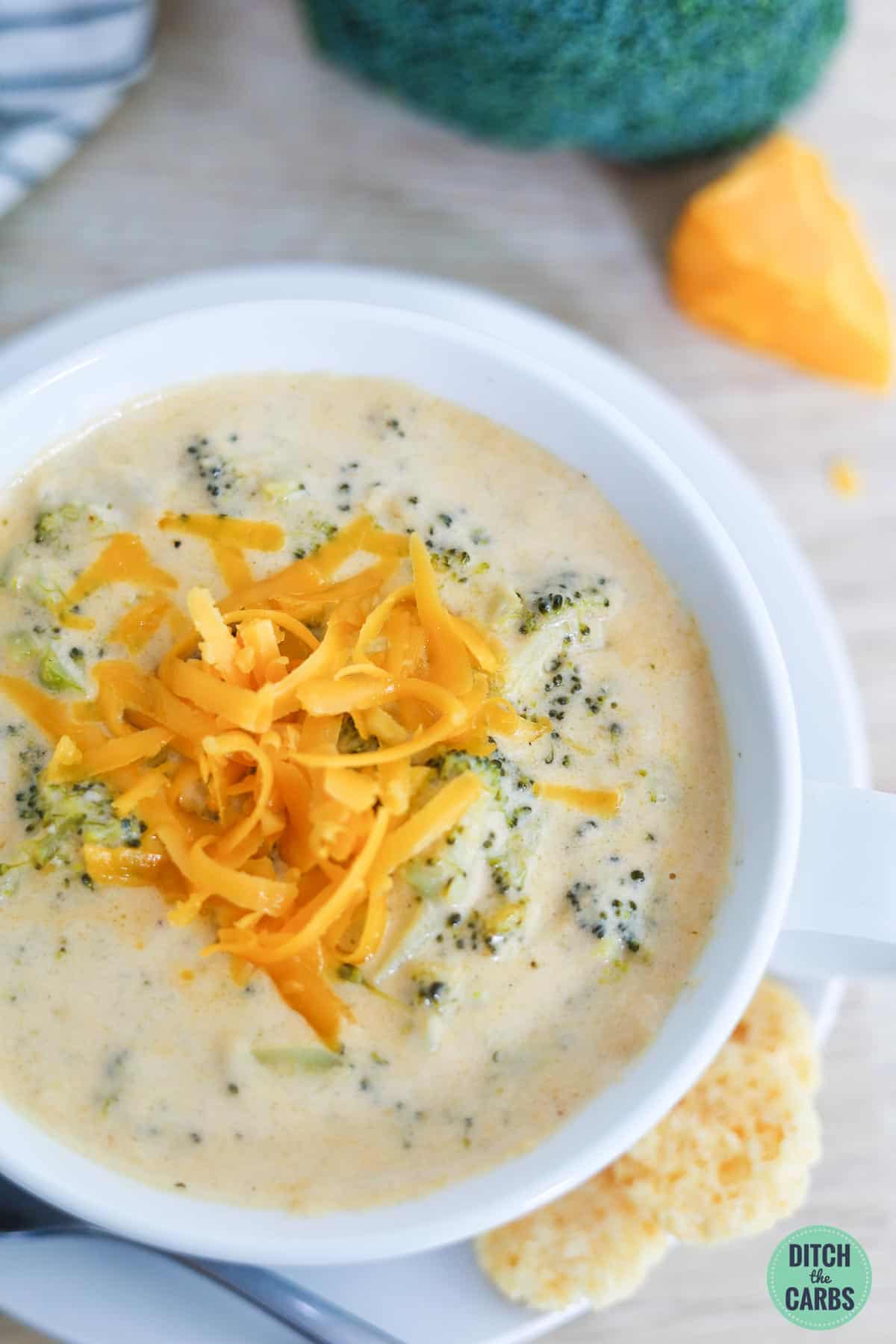 creamy broccoli cheese soup topped with shredded cheddar