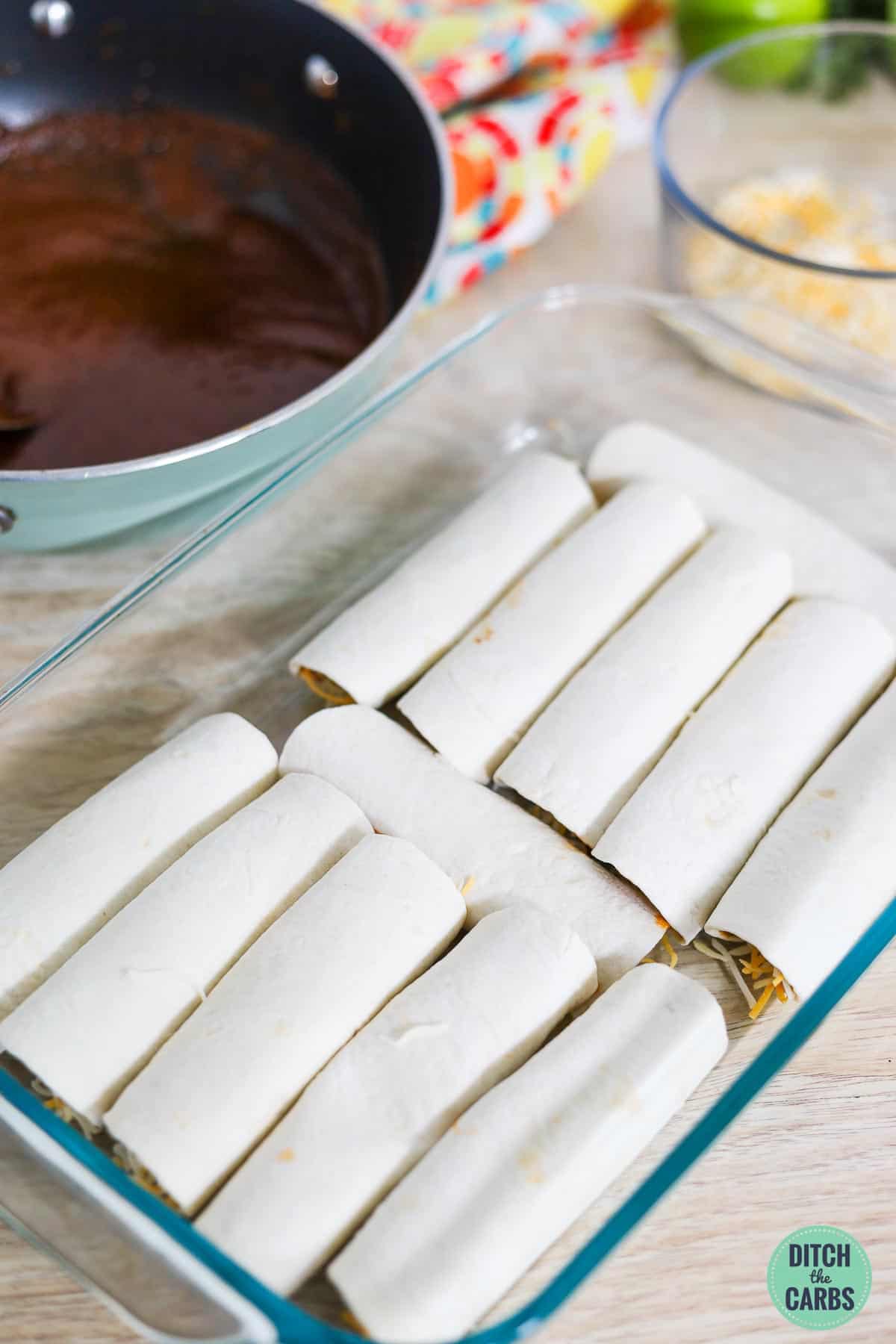 filled enchilada rolls in a baking dish