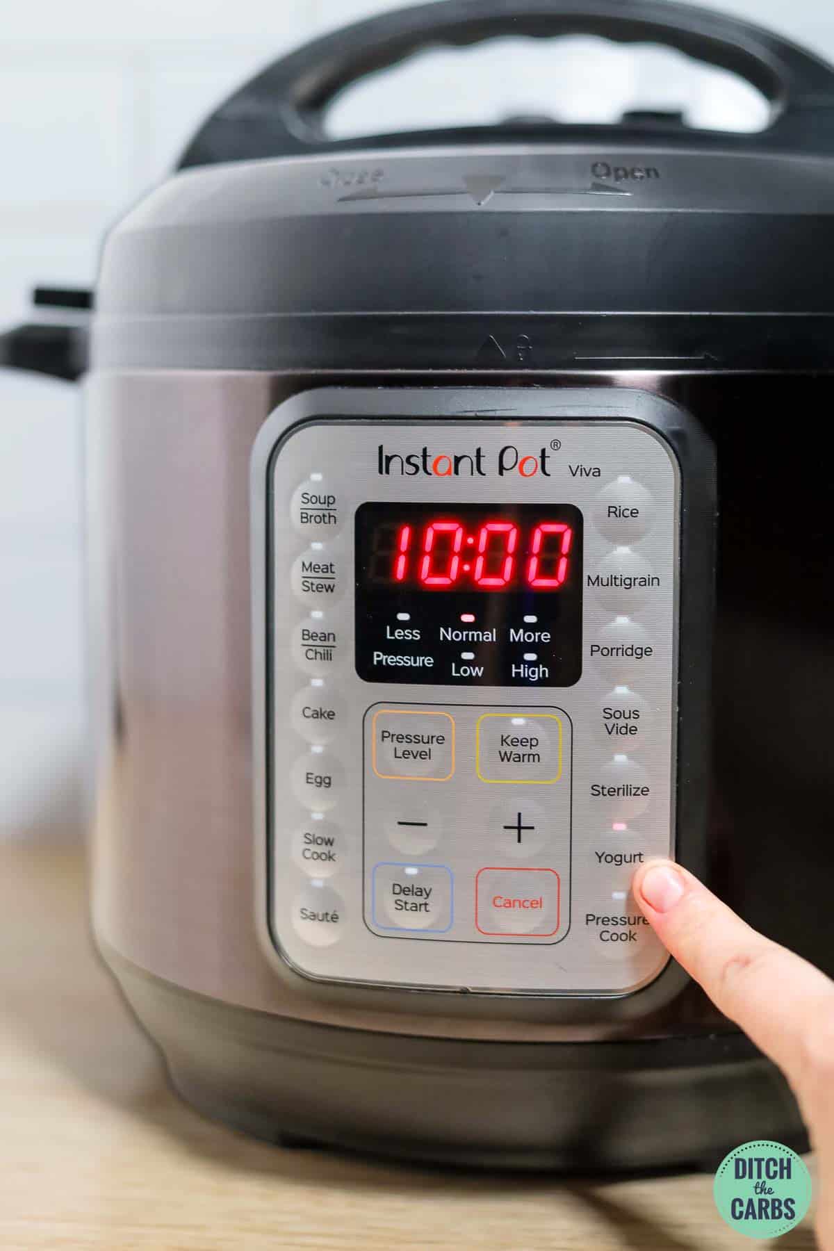 Setting the timer on the Instant Pot to incubate the yogurt using the yogurt setting.