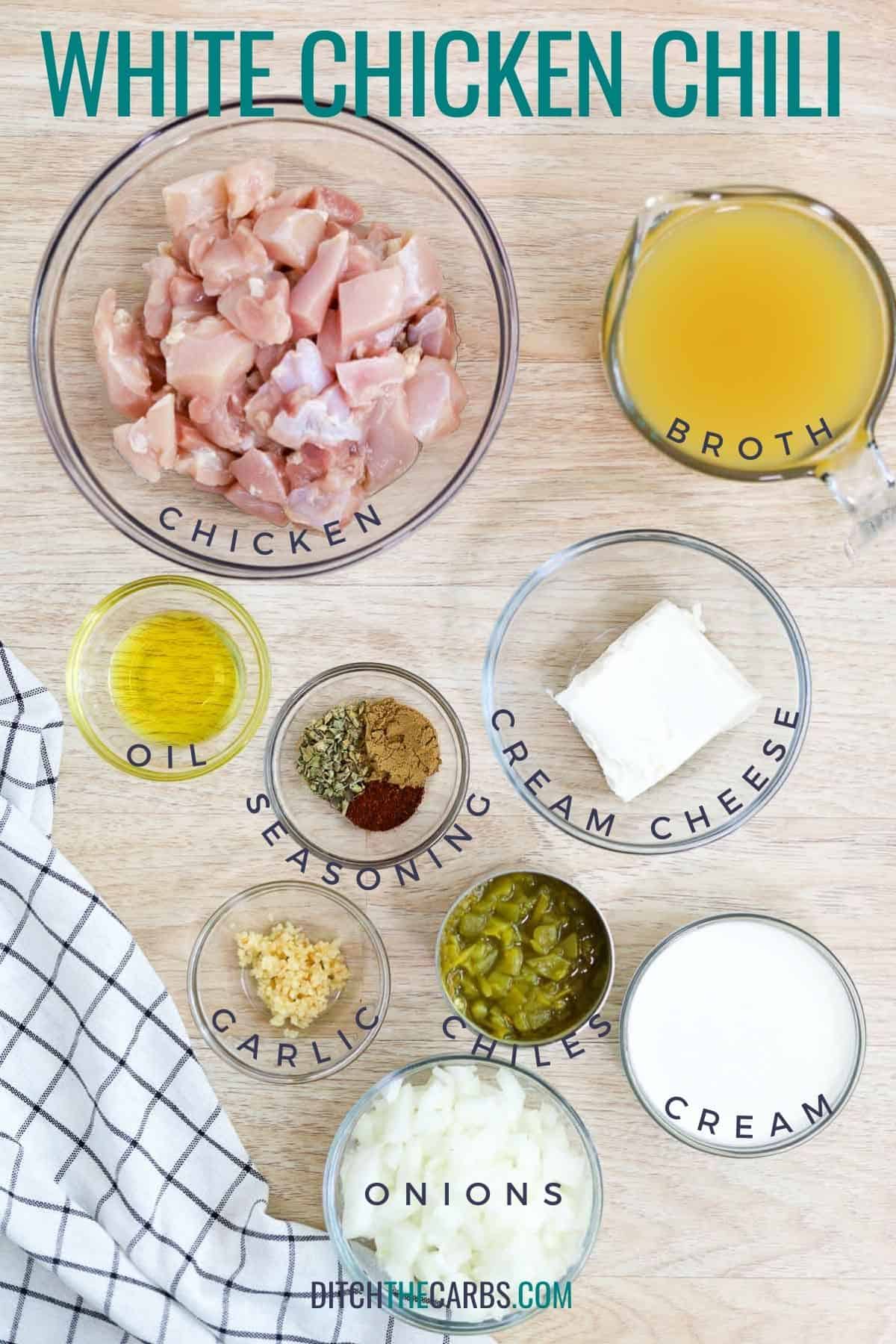 All the ingredients needed to make keto white chicken chili measure and placed in bowls on the counter.